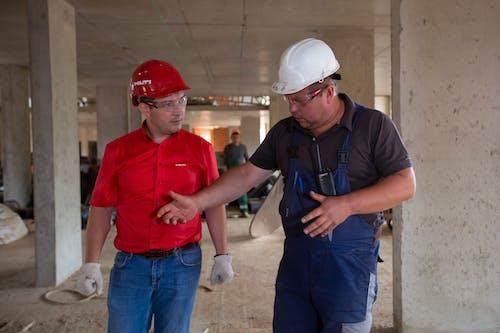 a man wearing a helmet standing next to a building